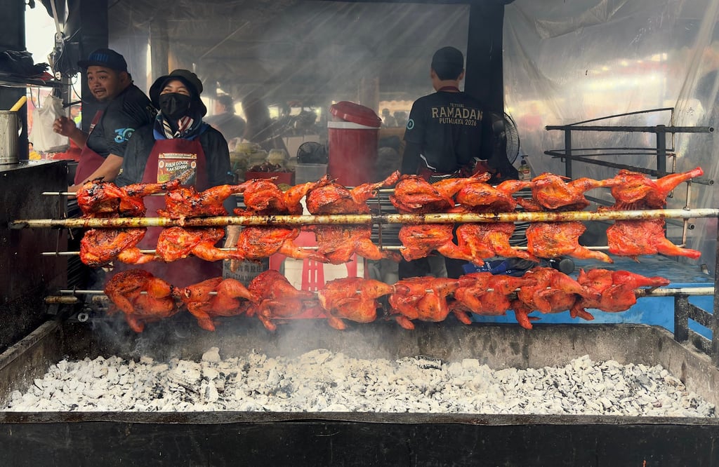 Chicken is grilled over charcoal at Nur Afifi’s stall in Putrajaya, where he says one month of sales can help cover the rest of the year. Photo: Iman Muttaqin Yusof