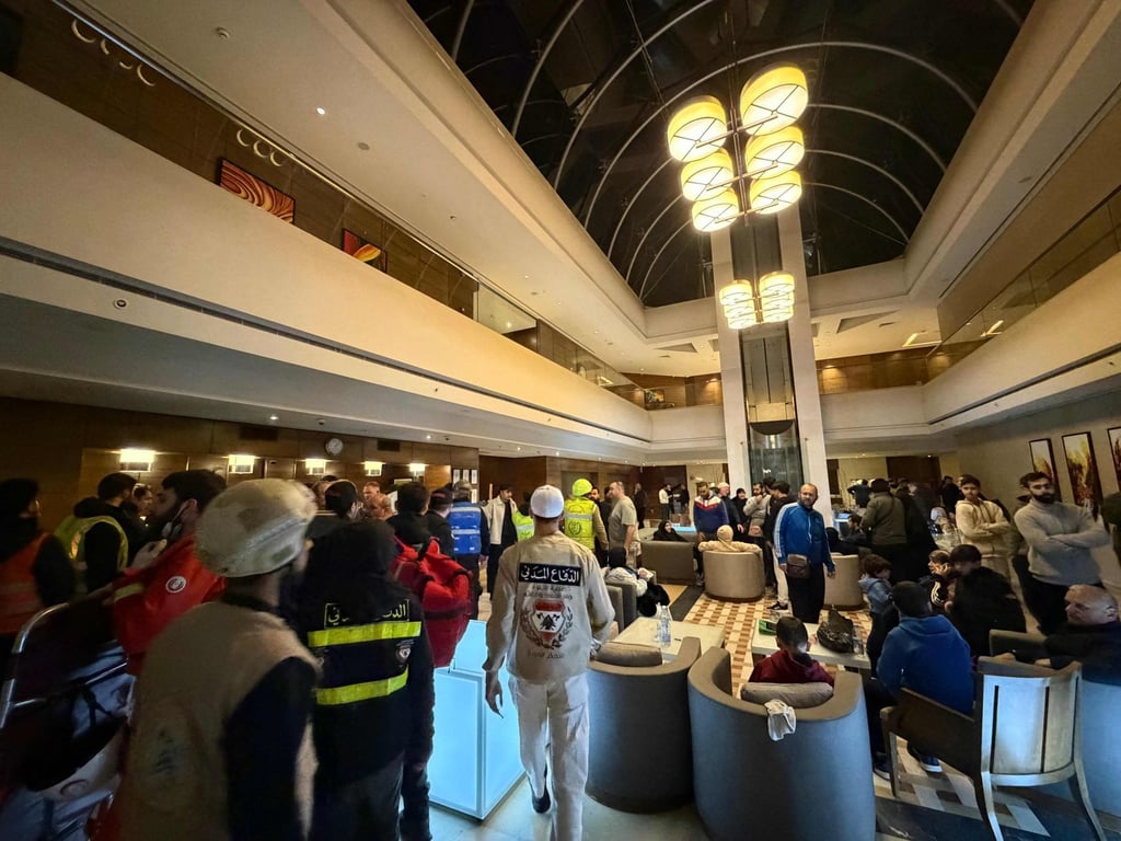 First aid responders are seen inside the lobby of the Ramada hotel in which a room was targeted by an Israeli strike, in Beirut, Lebanon, on Sunday. Photo: AFP