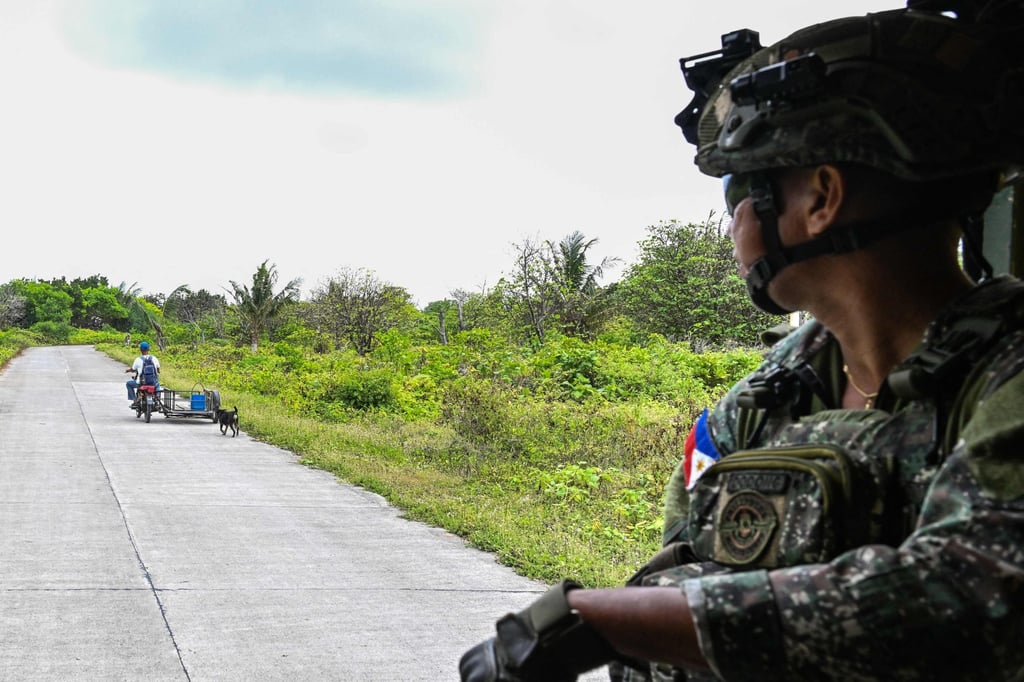 A Filipino soldier watches a resident pass by on Thitu Island in the South China Sea last month. The Philippines has been pivoting away from internal security towards territorial defence. Photo: AFP