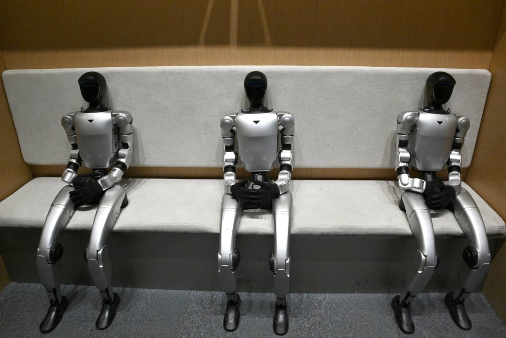 Three Unitree G1 humanoid robots sit at the company’s retail store in Beijing on January 9, 2026. Photo: AFP