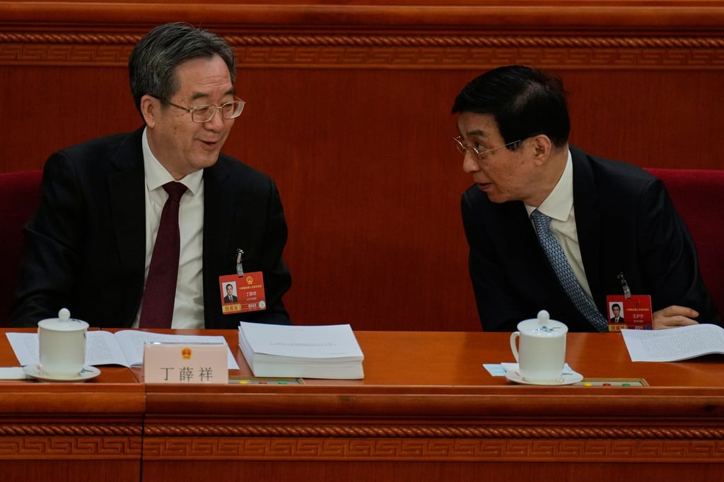 Politburo Standing Committee members Ding Xuexiang (left) and Wang Huning chat during the opening session of the National People’s Congress in Beijing, on March 5. Photo: AP