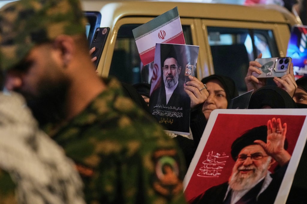 Shiite Muslims wave Iranian flags and hold portraits of late supreme leader Ayatollah Ali Khamenei and his son, Mojtaba Khamenei, during the annual Jerusalem Day rally in Baghdad on Friday. Photo: AP