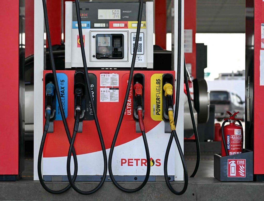Fuel pump nozzles are pictured at a Petros station in Kuching. Photo: AFP
