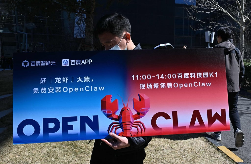 A man holds a placard featuring OpenClaw in Beijing. OpenClaw is an open-source AI agent framework that performs real-world tasks for users, much like a supercharged digital assistant. Photo: AFP