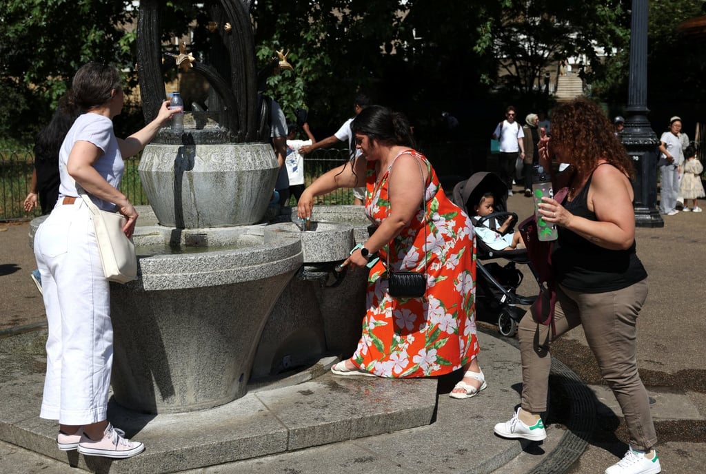 People refill their water bottles from a fountain in Green Park during a heatwave as the UK experienced record temperatures for the month of May, in London on May 25. Photo: Reuters