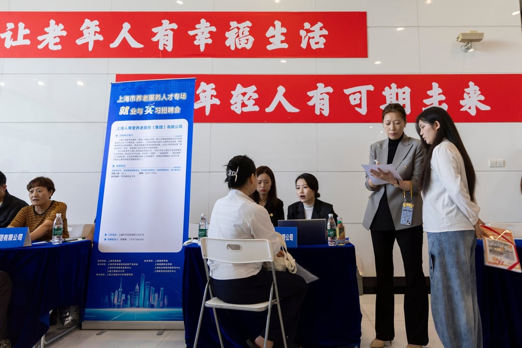 Job seekers talk to recruiters at a job fair on Songjiang campus of Shanghai University of Engineering Science in Shanghai. Photo: Xinhua