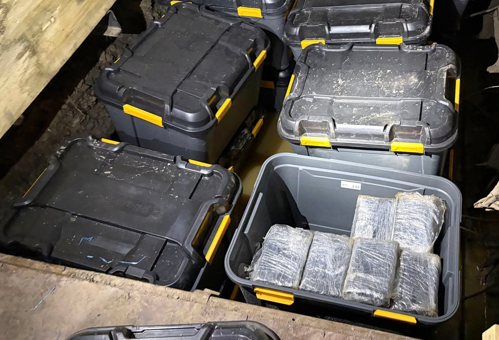 Cocaine is hidden in plastic tubs buried underground on the outskirts of Sydney. Photo: Australian Federal Police/AFP
