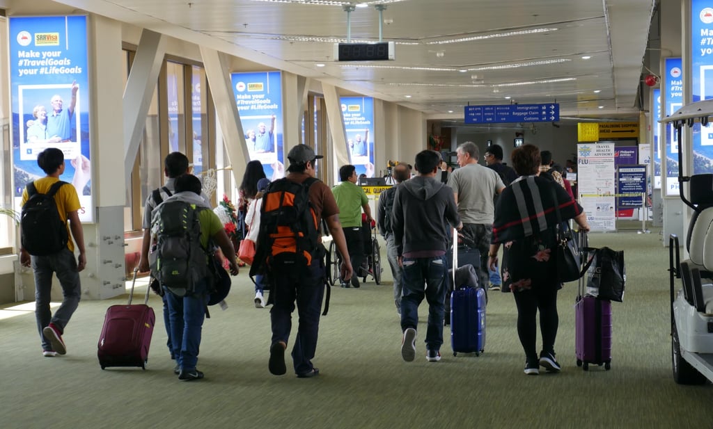 Passengers walk through Ninoy Aquino International Airport in Manila. Photo: Shutterstock