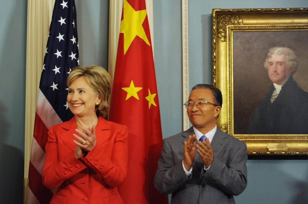 Then US secretary of state Hillary Clinton and then state councillor Dai Bingguo applaud beside a portrait of former US president Thomas Jefferson during the signing of a memorandum of understanding on clean energy and climate change in Washington on July 28, 2009. Photo: EPA