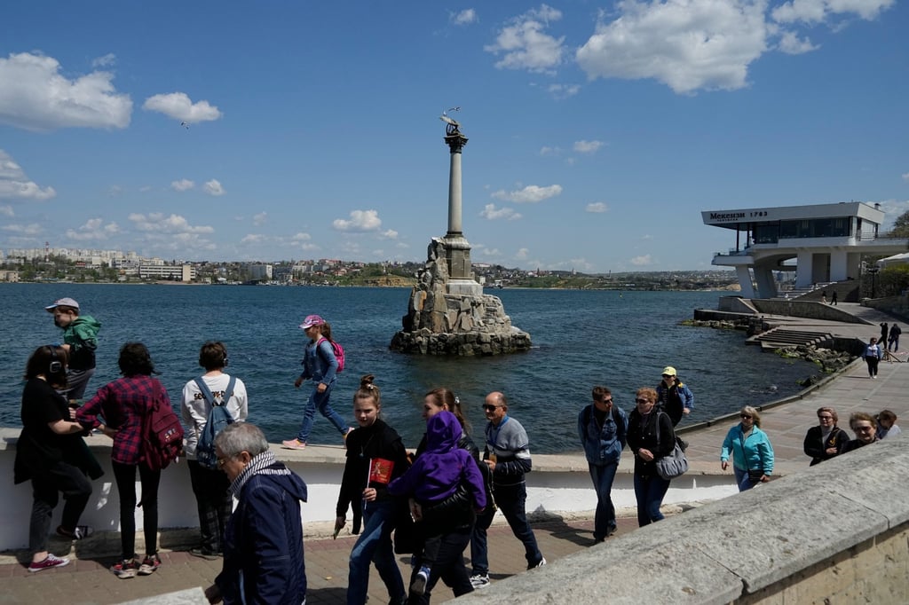 Tourists walk along an embankment in Sevastopol, Crimea, in 2022. Photo: AP