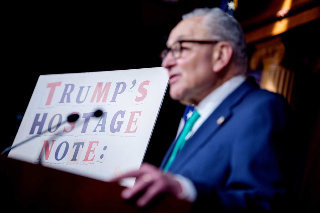 Senate Democratic Leader Chuck Schumer stands next to a poster that reads “Trump Hostage Note” as he speaks during a news conference on Capitol Hill on June 17. Photo: AP