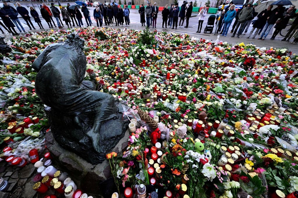 Flowers and candles placed in tribute to the hundreds of victims of a car-ramming attack on a Christmas market in Magdeburg, eastern Germany, in December 2024. Six people died. Photo: AFP