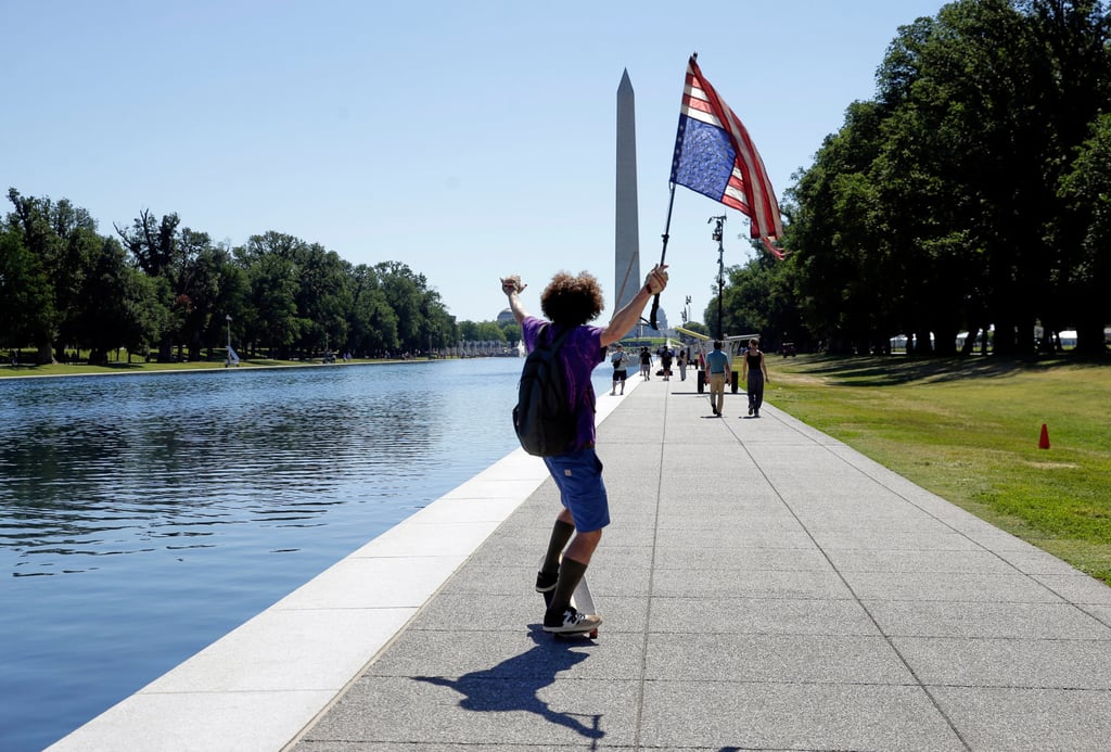 A man with an upside-down US flag is seen near the reflecting pool in Washington on Wednesday. Photo: AP