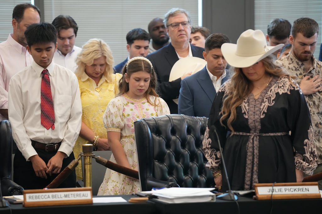 Audience members and State Board of Education member Julie Pickren (front right) pray before a meeting on social studies standards in Austin, Texas, on Friday. Photo: Austin American-Statesman via AP