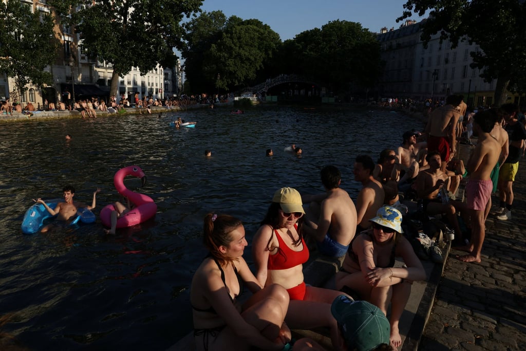 People swim in the Canal Saint-Martin after public swimming was permitted in certain areas due to high temperatures amid a heatwave in Paris, France, on Friday. Photo: Reuters