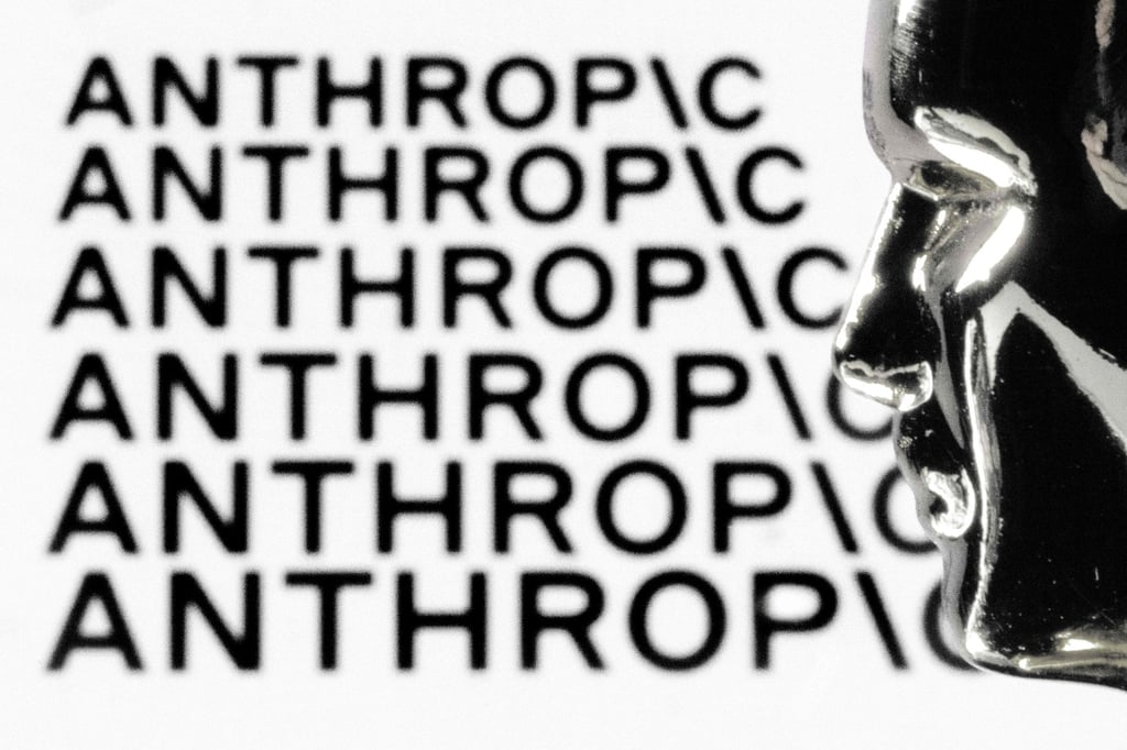 A figurine in front of the logo of AI company Anthropic. Photo: AFP