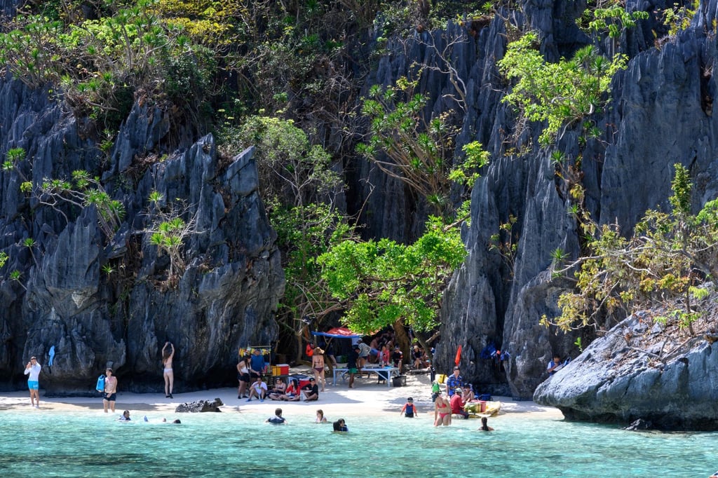 Tourists enjoy a beach on an island off the coast of Palawan province, the Philippines. Photo: AFP
