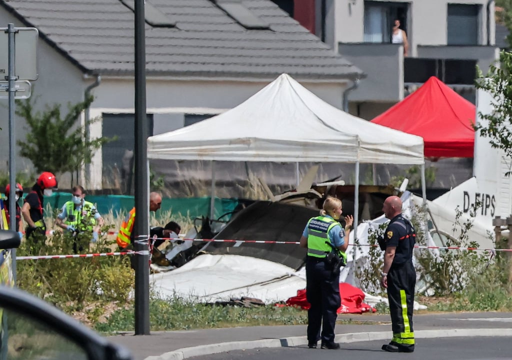 Rescuers work at the site of a plane crash in Tomblaine that killed 11 people. Photo: Reuters