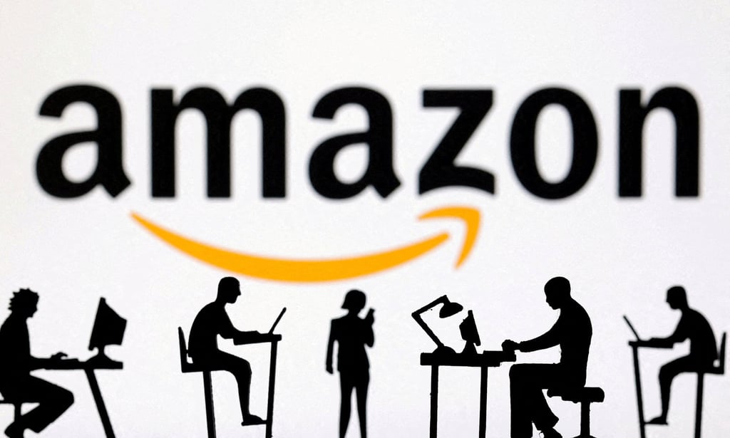 Figurines with computers and smartphones are seen in front of Amazon logo. Photo: Reuters