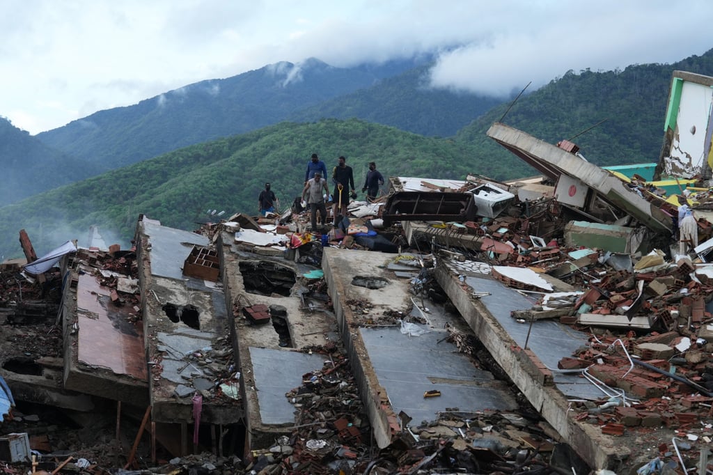 Residents search on Tuesday through the rubble of a building that collapsed during two earthquakes in La Guaira, Venezuela. Photo: AP