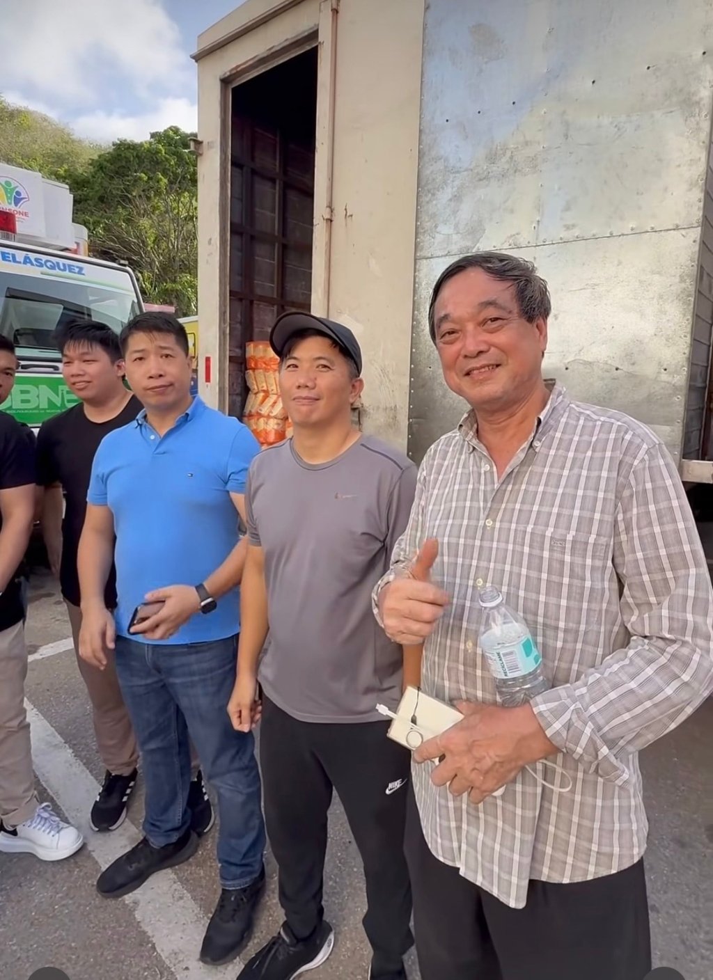 Lutao Cen (right) joins volunteers on Margarita Island as trucks carrying food, water and other donated supplies prepare to leave for communities affected by the earthquake.