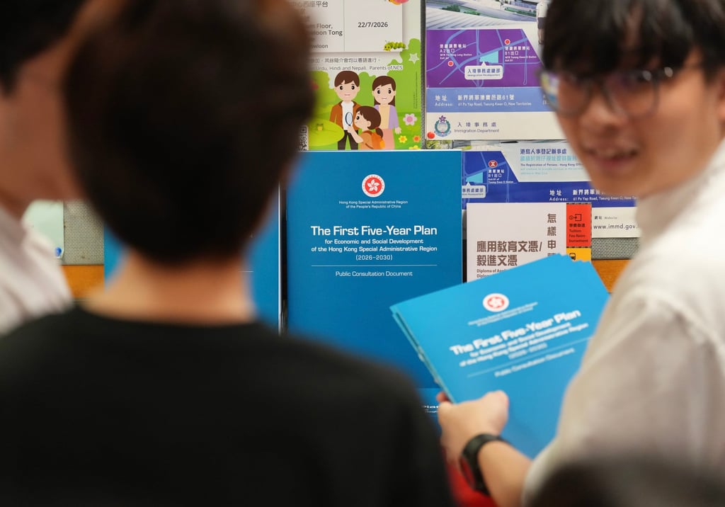 People collect copies of the consultation document for Hong Kong’s first five-year blueprint at the Wan Chai district Office on June 15. Photo: Karma Lo