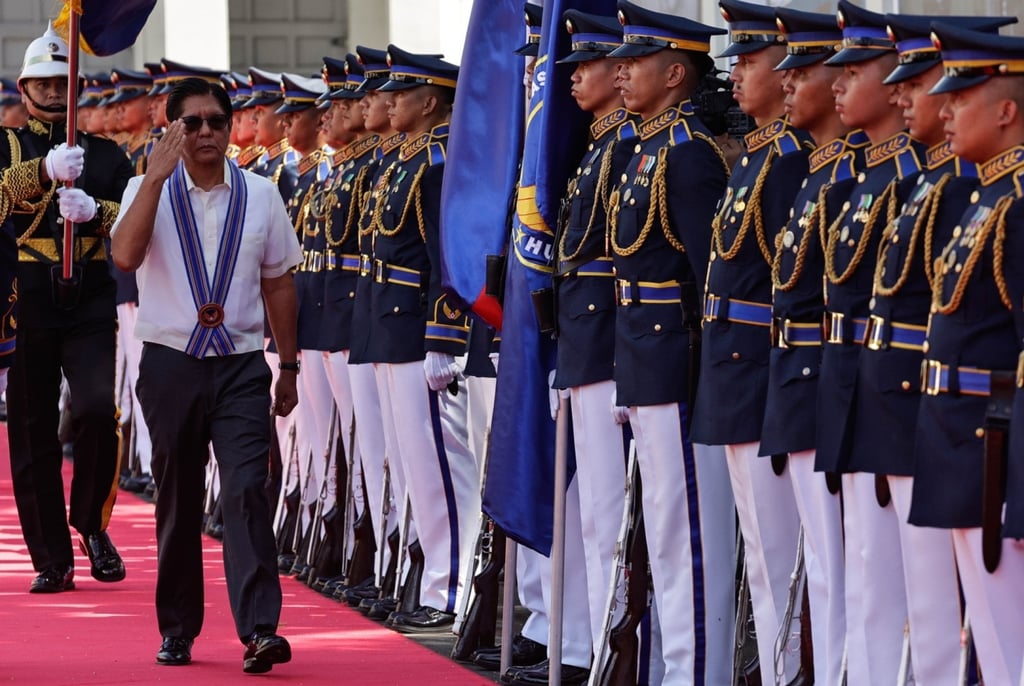 Philippine President Ferdinand Marcos Jnr salutes military honour guards at a ceremony marking the 79th founding anniversary of the Philippine Air Force at Villamor Air Base on Wednesday. Photo: EPA