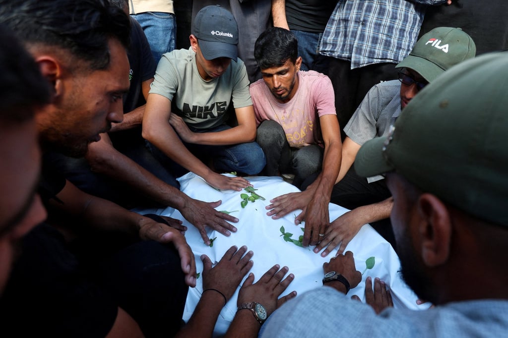 Mourners attend the funeral of three Palestinians, including a 10-year-old, who were killed in an Israeli strike. Photo: Reuters