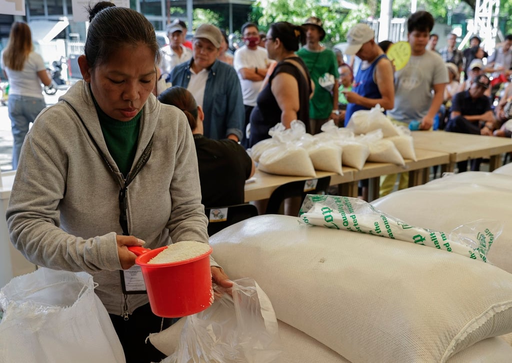 A government worker prepares bags of subsidised rice to be sold market in Quezon City, Metro Manila, last year. Photo: EPA-EFE