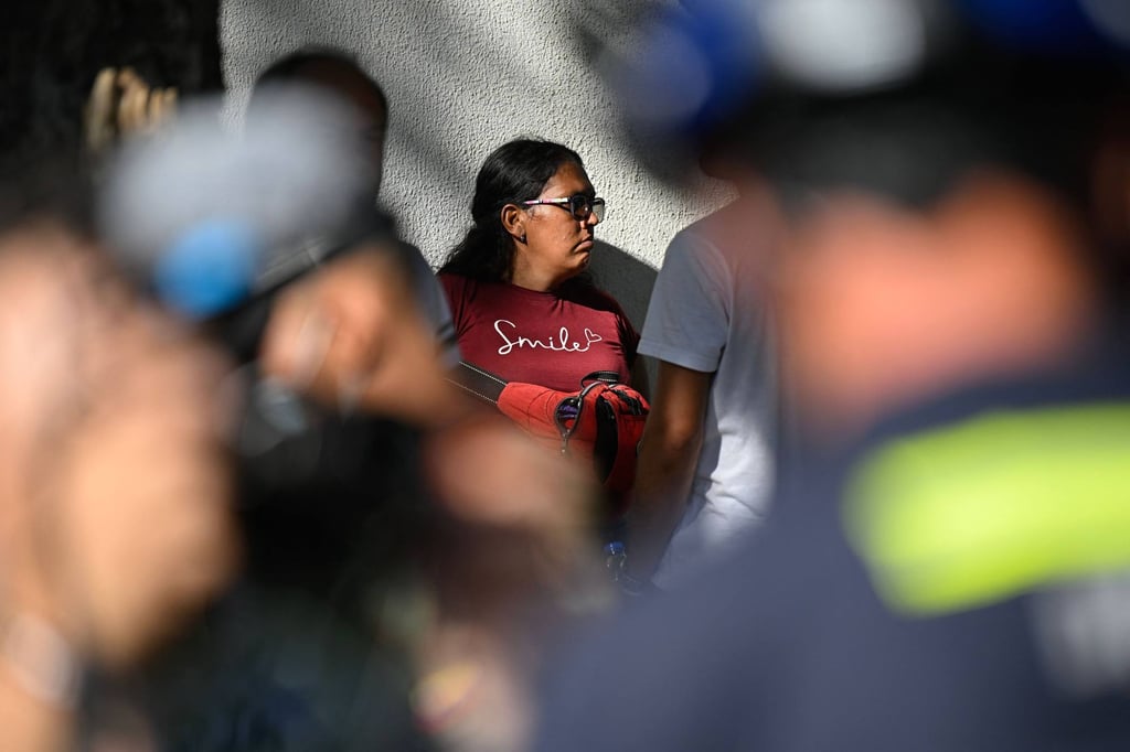 Hernan Gil’s wife, Gusbimar Gonzalez, is seen among rescuers before he was pulled out from the rubble in Catia La Mar on Thursday. Photo: AFP