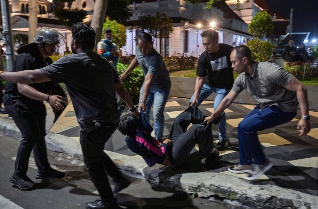 Indonesian police arrest a student following clashes during protest against a number of issues, including the government’s free meals programme, in Surabaya on June 26. Photo: AFP