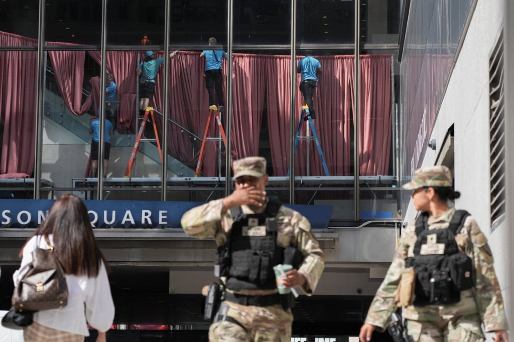 Workers operate inside Madison Square Garden in New York on Thursday, as members of the Armed Forces stand outside. Photo: Reuters
