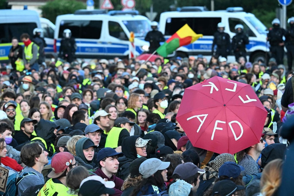 A participant holds up an umbrella with the lettering “F*** AfD” as people gather for a sit-in to block the access road at Gothaer Platz to the Messe Erfurt fairground in Erfurt, eastern Germany, on Saturday. Photo: AFP