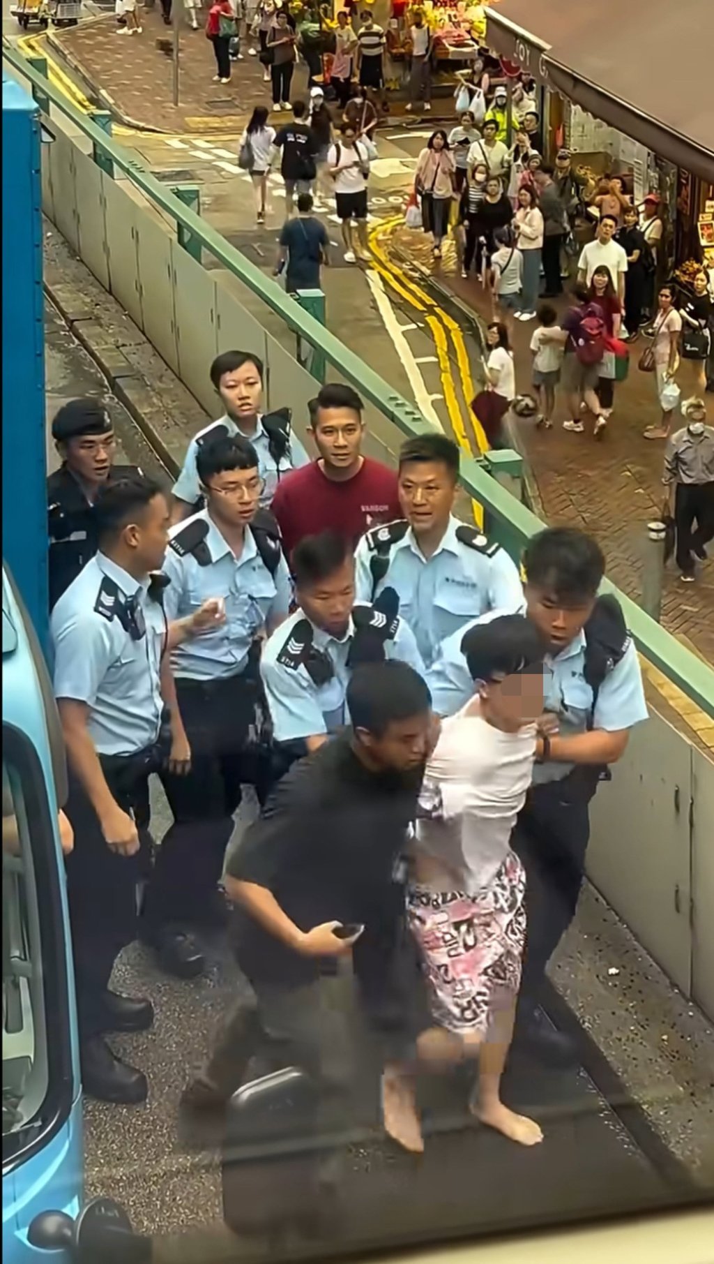 Officers lead away the driver after a high-speed chase across Hong Kong Island. Photo: Handout