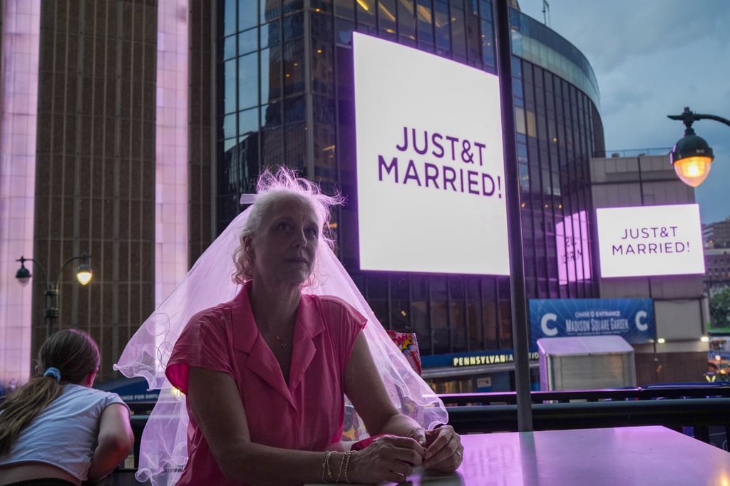 A Taylor Swift fan in a wedding veil sits at a restaurant next to Madison Square Garden on Friday. Photo: AP