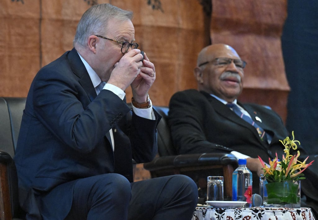 Australia’s Prime Minister Anthony Albanese drinks kava next to Fiji’s Prime Minister Sitiveni Rabuka during a welcome ceremony in Suva on Monday. Photo: AAP/Reuters