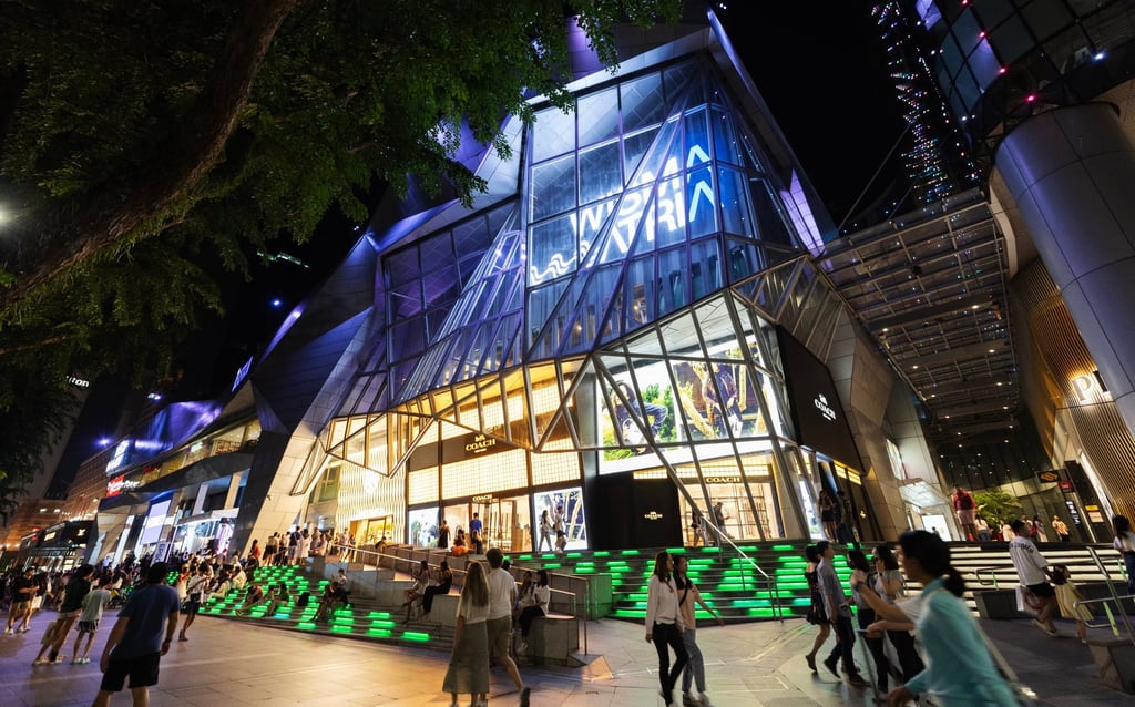 People walk past Wisma Atria shopping centre in Singapore’s luxury shopping area of Orchard Road in March 2024. Photo: EPA-EFE