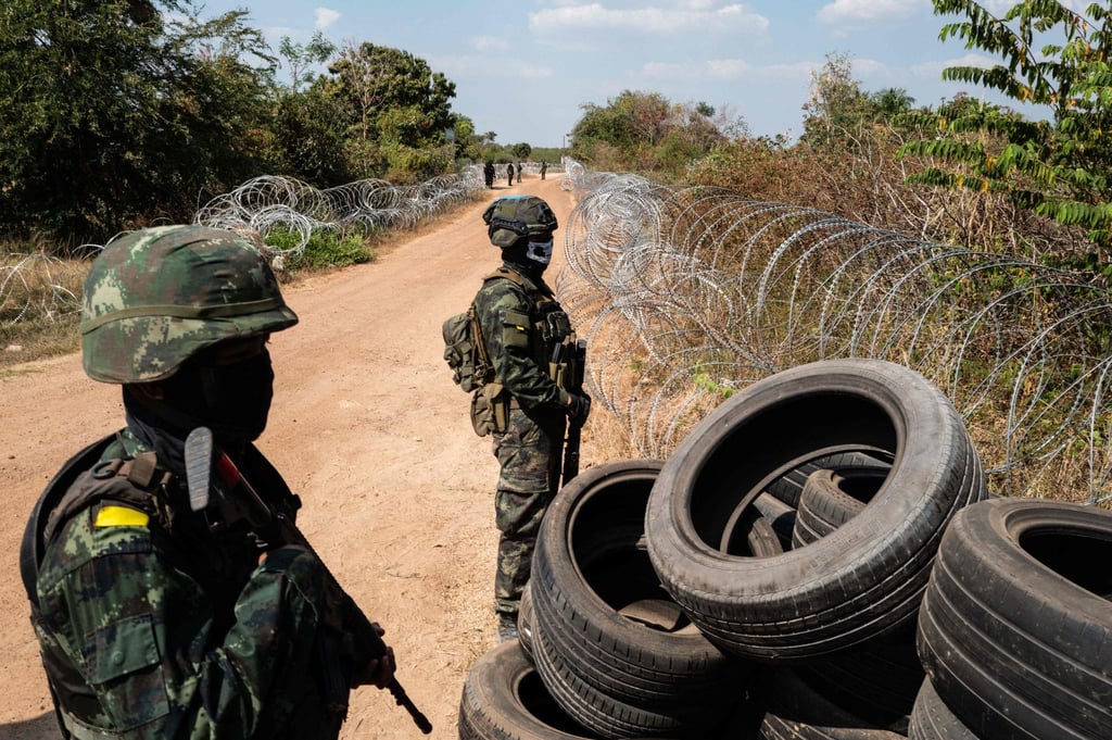 Thai soldiers stand guard near barbed wire and tyres installed to mark the border with Cambodia, near Sadok Kok Thom Historical Park in Thailand’s Sa Kaeo province, on February 5. Photo: AFP