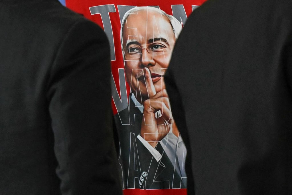A supporter of Malaysia’s former prime minister Najib Razak wears a shirt with his image in Putrajaya in 2025. Photo: AFP