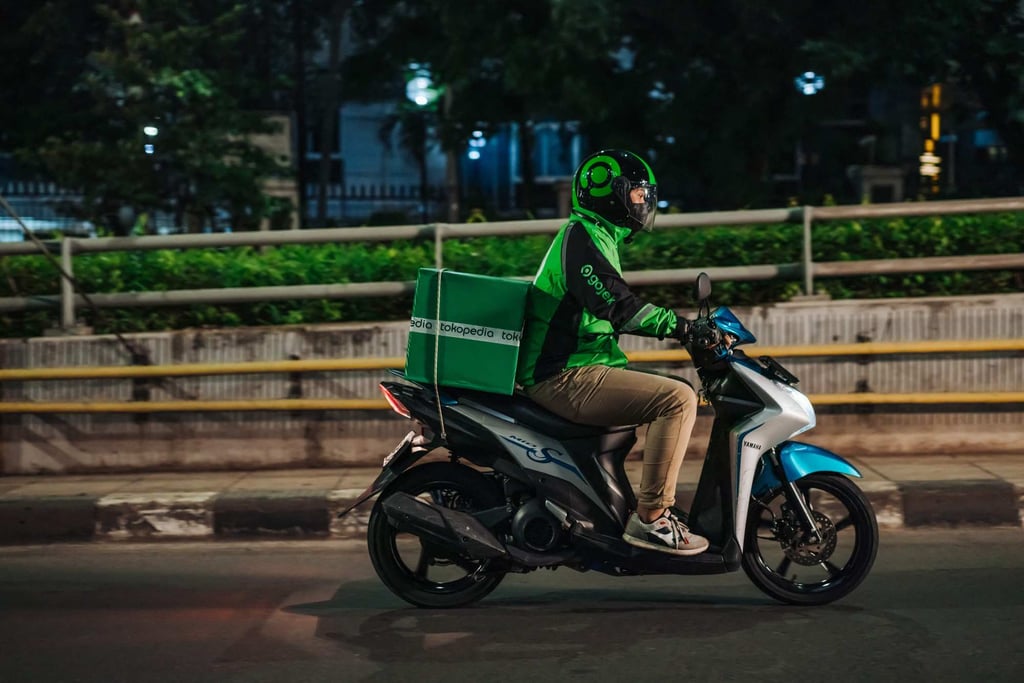 A Gojek rider delivering a Tokopedia package to a customer in Jakarta, Indonesia. Photo: GoTo Group / AFP