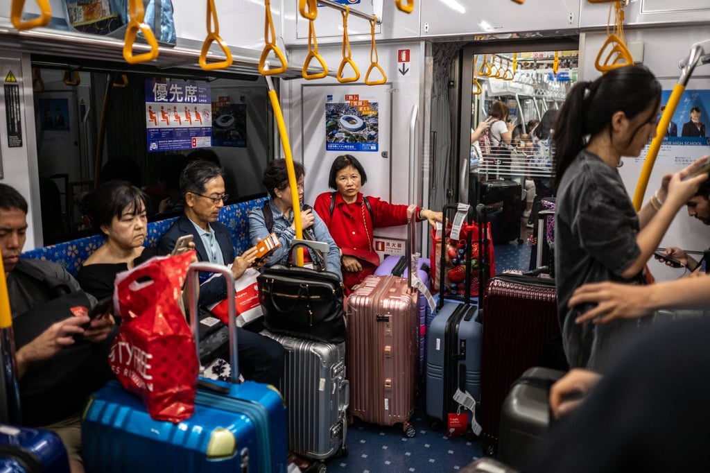 Tourists travel on a subway train to Tokyo’s city centre from Narita International Airport. Photo: AFP