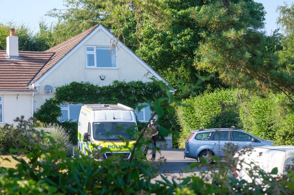 Police officers stand outside Ann Widdecombe’s home in Haytor on Friday. Photo: PA Wire via dpa