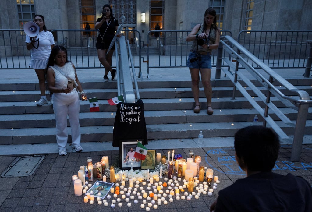 People gather next to a makeshift memorial during a vigil for Lorenzo Salgado Araujo on Sunday, who was fatally shot by an ICE agent in Houston last week. Photo: Reuters
