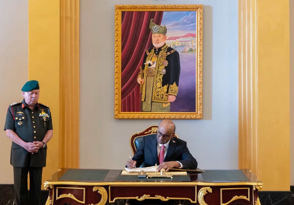Singapore President Tharman Shanmugaratnam signs the guest book as Malaysian King Sultan Ibrahim Iskandar looks on. Photo: Facebook/officialsultanibrahim