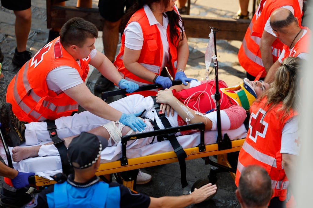 Medical services transport a runner after he is gored during the final bull run of the San Fermin festival in Pamplona on Tuesday. Photo: EPA