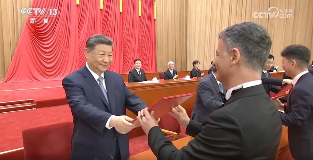 Artem Oganov receives the International Science and Technology Cooperation Award from Chinese President Xi Jinping in Beijing on July 8. Photo: CCTV