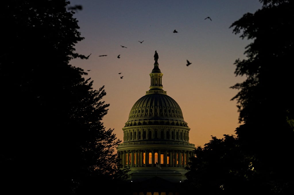 The sun sets near the US Capitol on Monday. Photo: Reuters