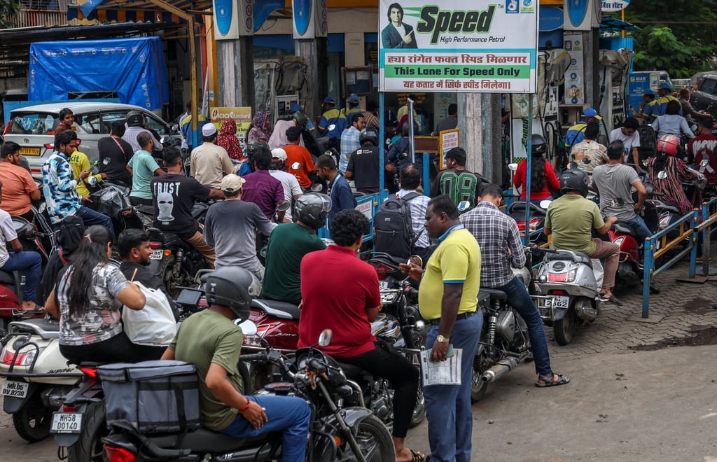 Motorcyclists queue at a petrol station in Mumbai on July 9. Photo: EPA