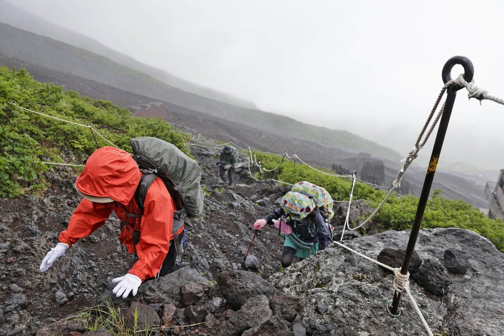 Hikers make their way up Mount Fuji in 2024 as the summer climbing season was about to begin. Photo: Kyodo