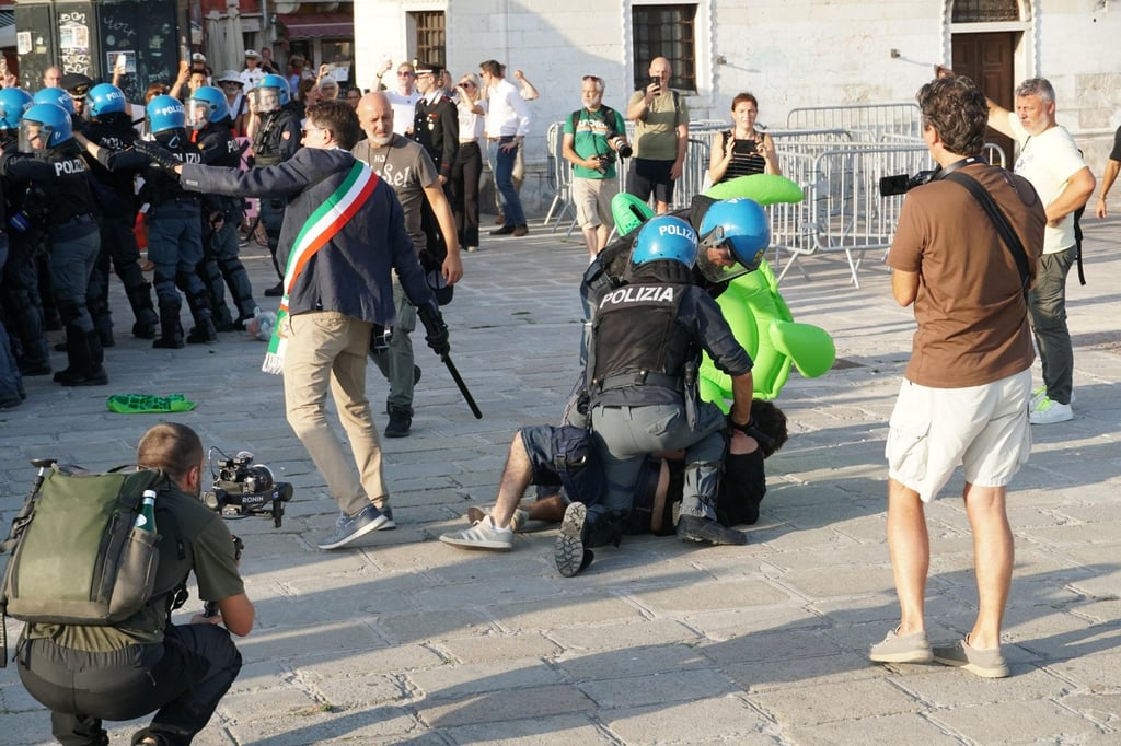 A person is detained by police during a protest against a visit by US Ambassador to Italy Tilman Fertitta in Venice on Friday. Photo: EPA
